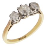 An 18ct gold mounted three stone diamond set ring on an 18ct gold band size L, centre stone