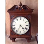 A late 19th century mahogany wall clock with scrolled mahogany pediment the painted dial with