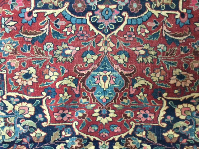 A pair of early 20th century Persian carpets the quartered madder field with central turquoise and - Image 5 of 6