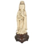 An ivory figural carving of Quan Lin, early 20th century modelled standing wearing trailing robes