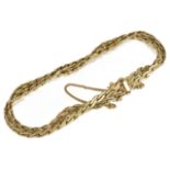 A Continental .585 gold flat weave twin chain bracelet the articulated chains twisted together and