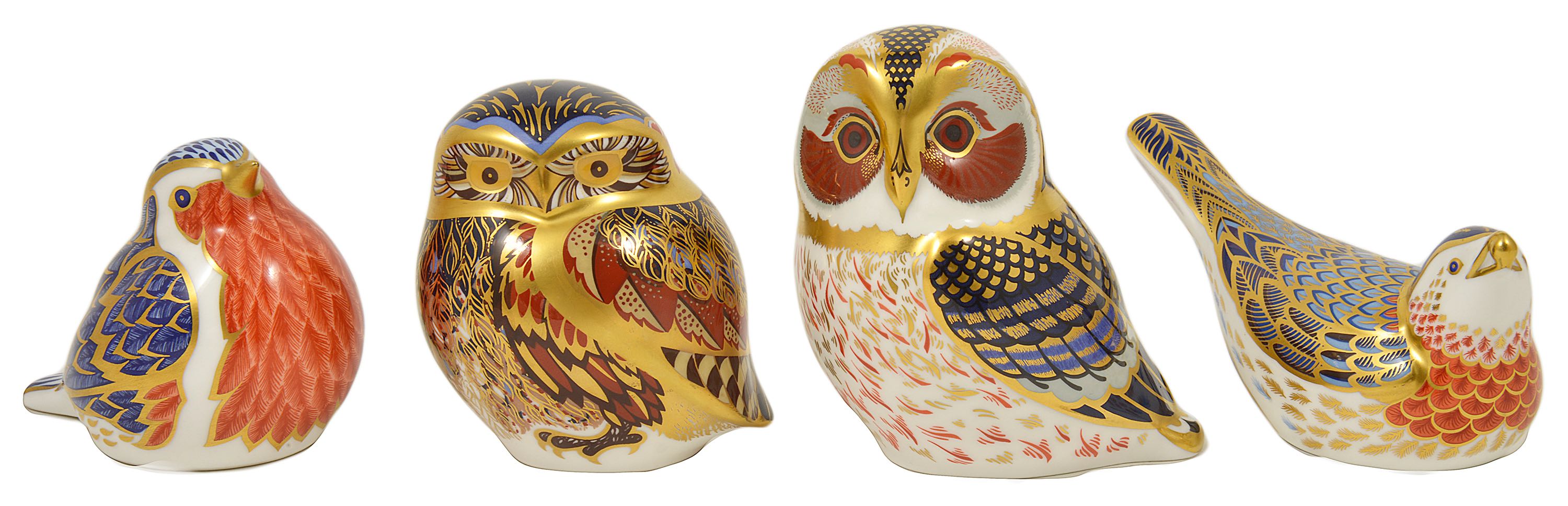 Four Royal Crown Derby paperweights in the form of birds including two owls, a robin and another,