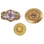 A large Victorian amethyst set gold scroll brooch and two other brooches the amethyst brooch of