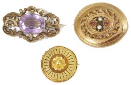 A large Victorian amethyst set gold scroll brooch and two other brooches the amethyst brooch of