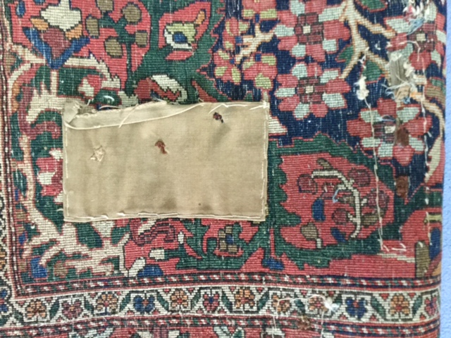 An early 20th century Persian carpet, possibly Kashan the quartered indigo field with central floral - Image 6 of 6