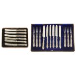 A cased set of silver handled fruit knives and forks in blue velvet lined case, the handles