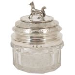 A silver plated and glass jar and cover, the cover with terrier shaped finial and engraved