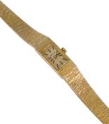 A Longines ladies 9ct gold bracelet wristwatch the integral bracelet with bark effect finish, having