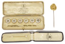 Two Victorian stick pins and a cased set of studs the larger pin of Etruscan style in the form of