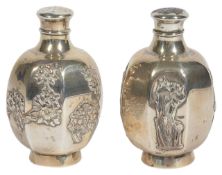 Two Japanese silver pepperettes, Meji Period of octagonal form with twist on pierced lids, the