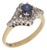 An attractive sapphire and diamond set fancy ring having central circular sapphire high mounted