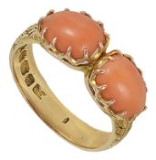 A Victorian two stone coral mounted ring the scroll engraved 18ct gold mount set with a pair of