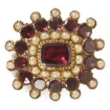 A Georgian garnet and seed pearl brooch with central rectangular flat cut garnet set within a