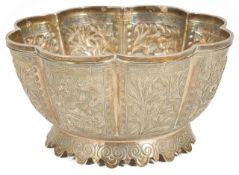 A 19th century Chinese white metal bowl of flower form, each panel individually embossed with either
