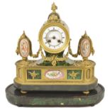 A French porcelain mounted ormolu mantle clock circa 1860 inset with simulated green stained