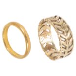 A narrow 22ct gold plain wedding band and another 9ct gold pierced, foliate wedding band, both fully