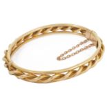 A Victorian 15ct gold rope twist bangle bangle of hinged construction with central rope twist with