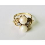 A two stone diamond and pearl fancy ring of unusual design the 18ct gold mount set with twin