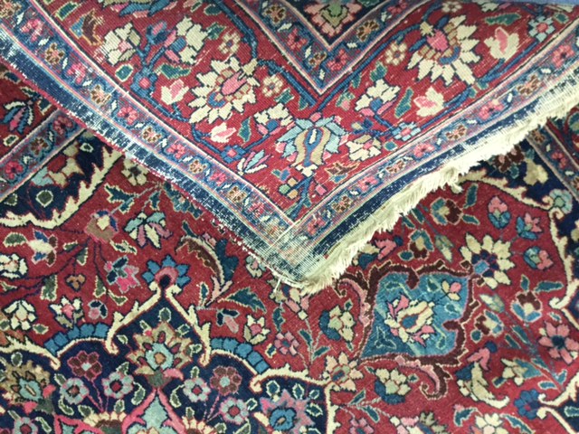 A pair of early 20th century Persian carpets the quartered madder field with central turquoise and - Image 6 of 6