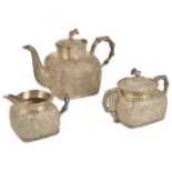 A good quality Chinese export ware white metal three piece tea set of squat square shaped form,