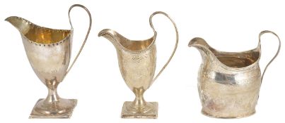 Three George III silver cream jugs, comprising of a George III silver cream jug, London 1805 with