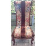 A Victorian mahogany prie-dieu chair with cabriole legs to the front and upholstery with tapestry