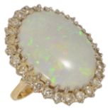 A large oval opal and diamond set cluster ring the oval precious opal measuring approx. 22 x 17