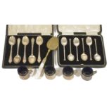 A collection of silver spoons and four silver holder blue glass cups A cased set of six silver