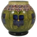 A Moorcroft tube lined Violet vase, by William John Moorcroft the bulbous body with violet