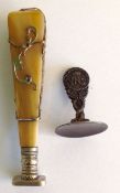 A late 19th century horn desk seal, of tapered form with applied white metal decorative foliage,