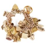 A heavy 9ct gold rose gold double curb link charm bracelet hung with a variety of gold charms