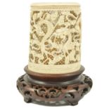 A Chinese 19th century carved ivory brush stand the cylindrical shaped holder carved with several