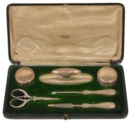 A Mappin and Webb silver manicure set the green velvet lined case comprising two silver lidded pots,