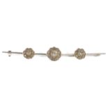 An Edwardian diamond set tripple daisy cluster bar brooch the white metal bar set with a central