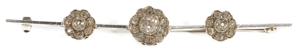 An Edwardian diamond set tripple daisy cluster bar brooch the white metal bar set with a central