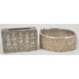 An early 20th century Indian white metal bangle and a similar match box holder the hinged bangle,