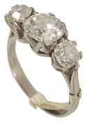 An attractive antique three stone old cut diamond set ring the centre stone of slightly oval form