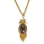 A Victorian large garnet set oval drop pendant on fancy chain the oval cabochon garnet mounted in