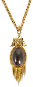 A Victorian large garnet set oval drop pendant on fancy chain the oval cabochon garnet mounted in