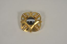 A good quality Victorian banded agate and pearl set mourning brooch having central cabochon polished