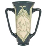A Moorcroft Collectors Club twin handled vase, with lily pattern tubelined on a green body, green