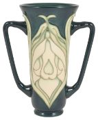 A Moorcroft Collectors Club twin handled vase, with lily pattern tubelined on a green body, green