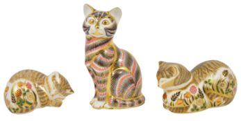 A group of three Royal Crown Derby paperweights in the form of cats and kittens the first modelled