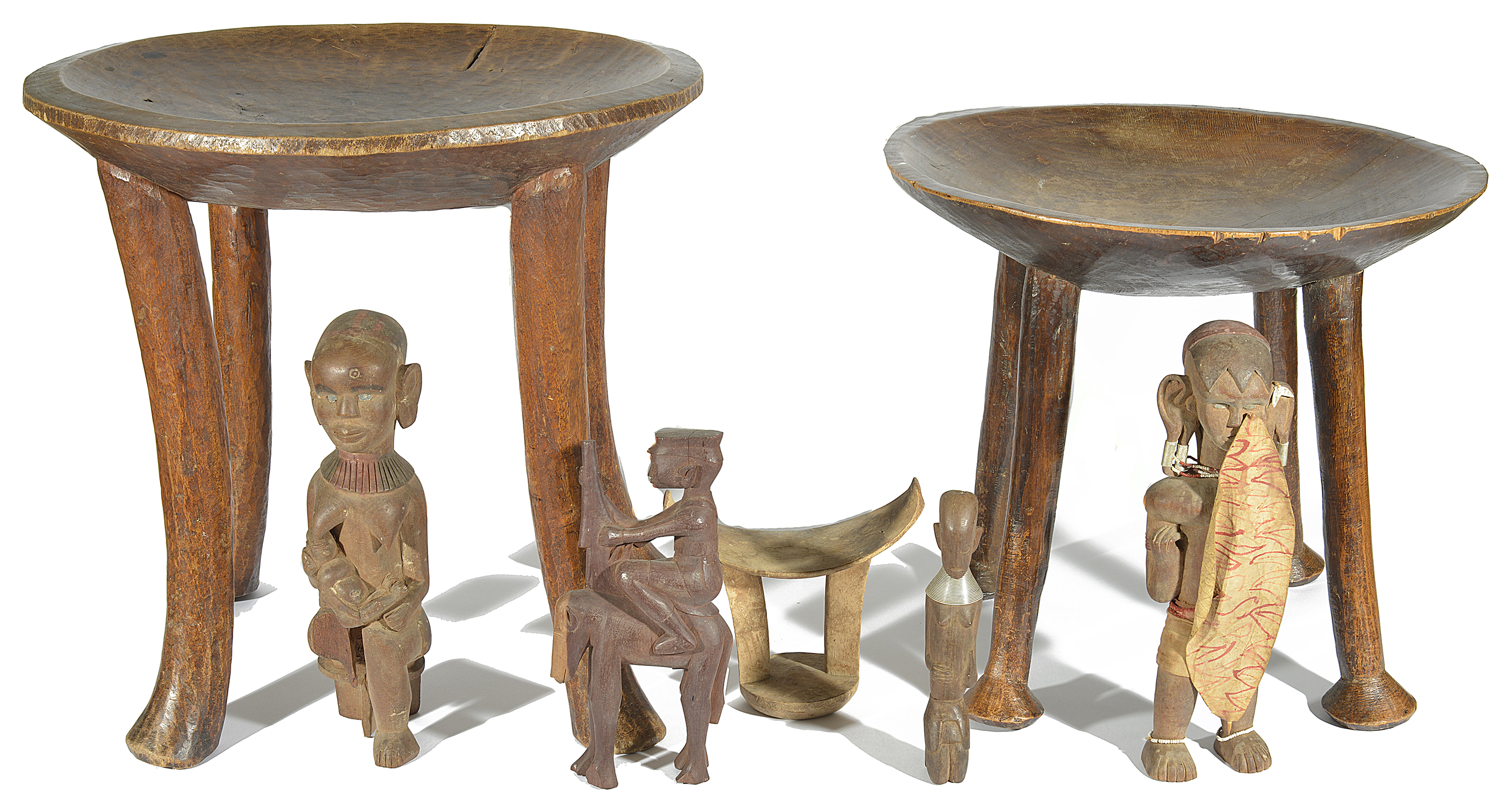 Two 20th century African tribal stools, each with dished seats upon four supports, together with a - Image 2 of 3