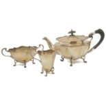 An Edwardian three piece silver tea service, Birmingham 1919 comprising of a teapot with wooden