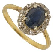 A sapphire and diamond cluster ring the oval sapphire set within a border of small diamonds, mount