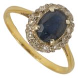 A sapphire and diamond cluster ring the oval sapphire set within a border of small diamonds, mount