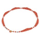 An attractive Edwardian natural coral woven bead necklace the woven bead sections spaced with