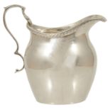 An Edwardian small silver cream jug, Birmingham 1919 with gadrooned border and acanthus leaf handle,