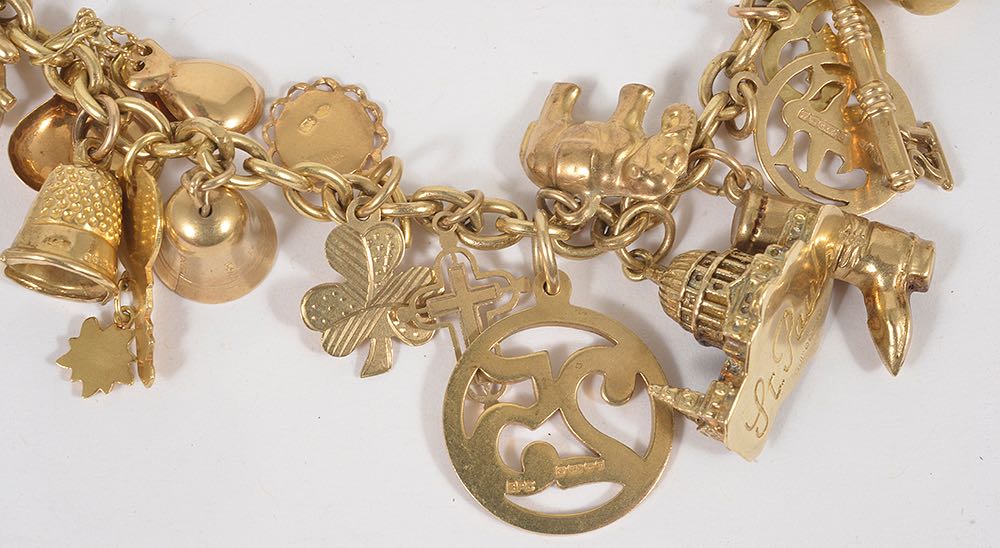 A selection of mainly 9ct gold and yellow metal charms suspended from a gilded metal bracelet, 9ct - Image 3 of 4